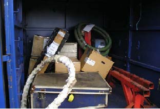 The contents of a freight container are left unsecured. Some are labelled as fragile