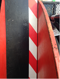 Added strip of additional guarding and safety tape to highlight potential 'pinch' points to operators